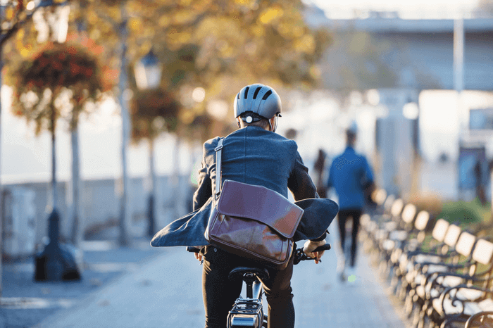 Pendlervorteil: Mann in Geschäftskleidung auf einem Fahrrad